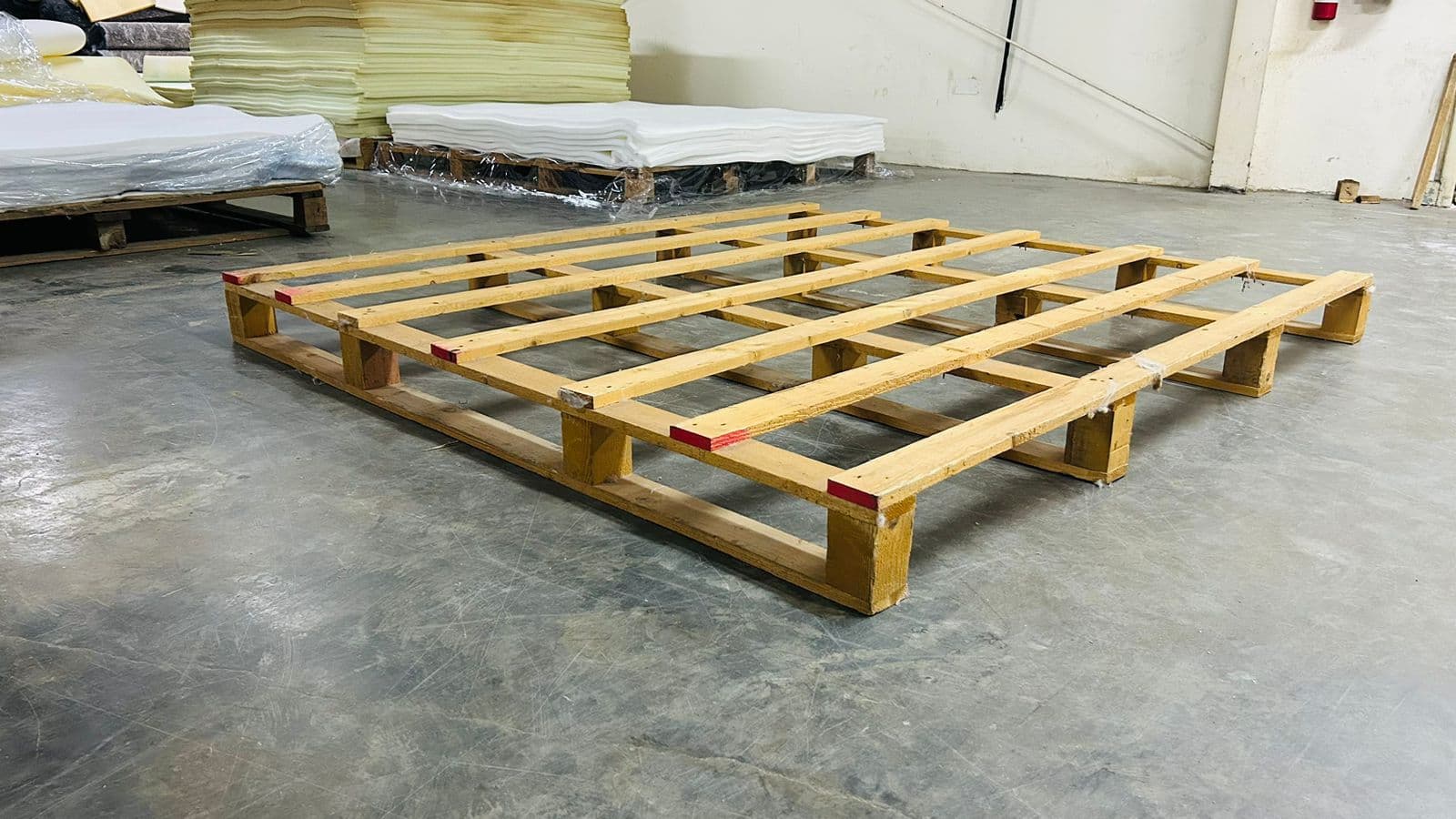 Custom heavy-duty wooden pallet on a warehouse floor